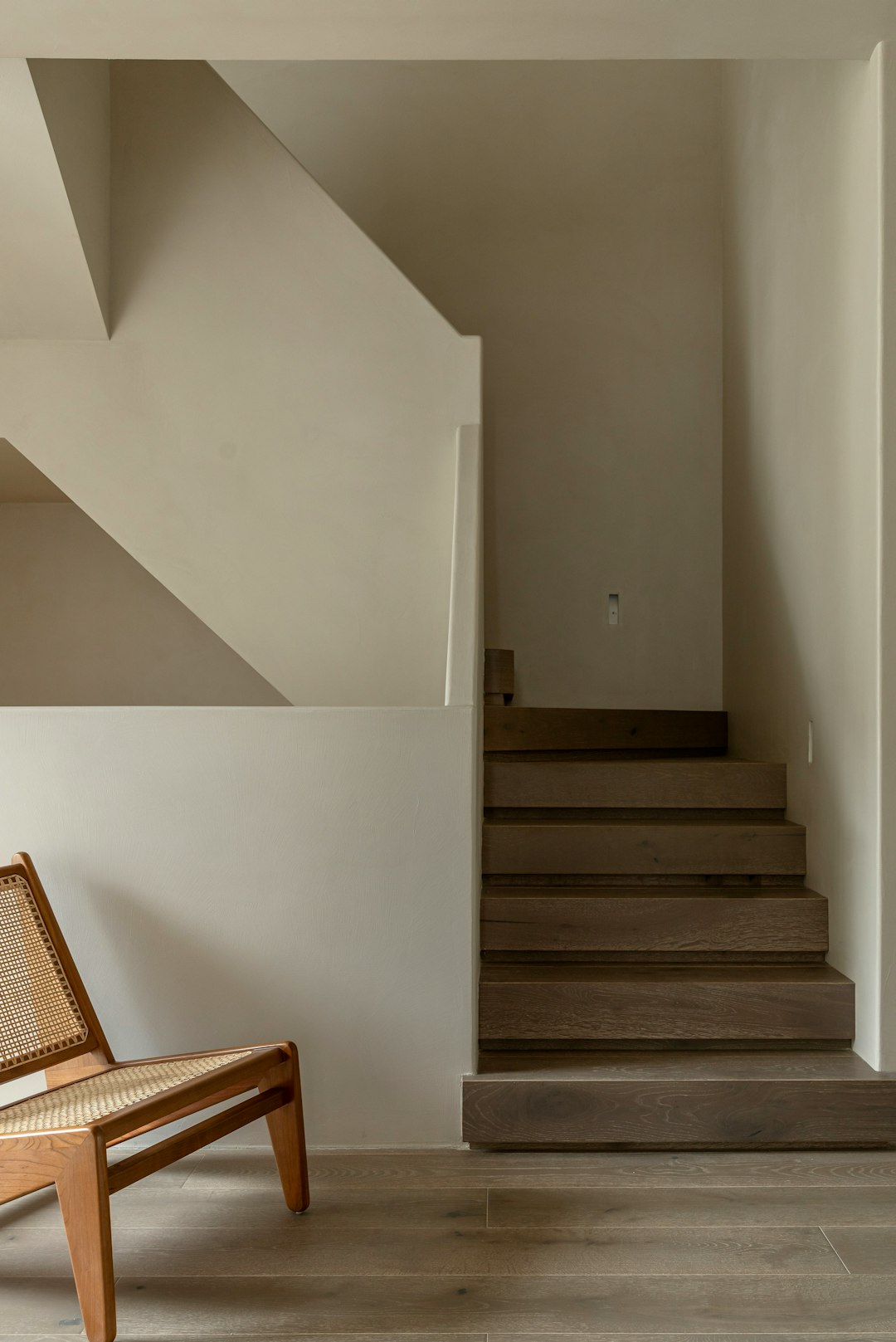 a-staircase-with-a-chair-qtszsit0kk8